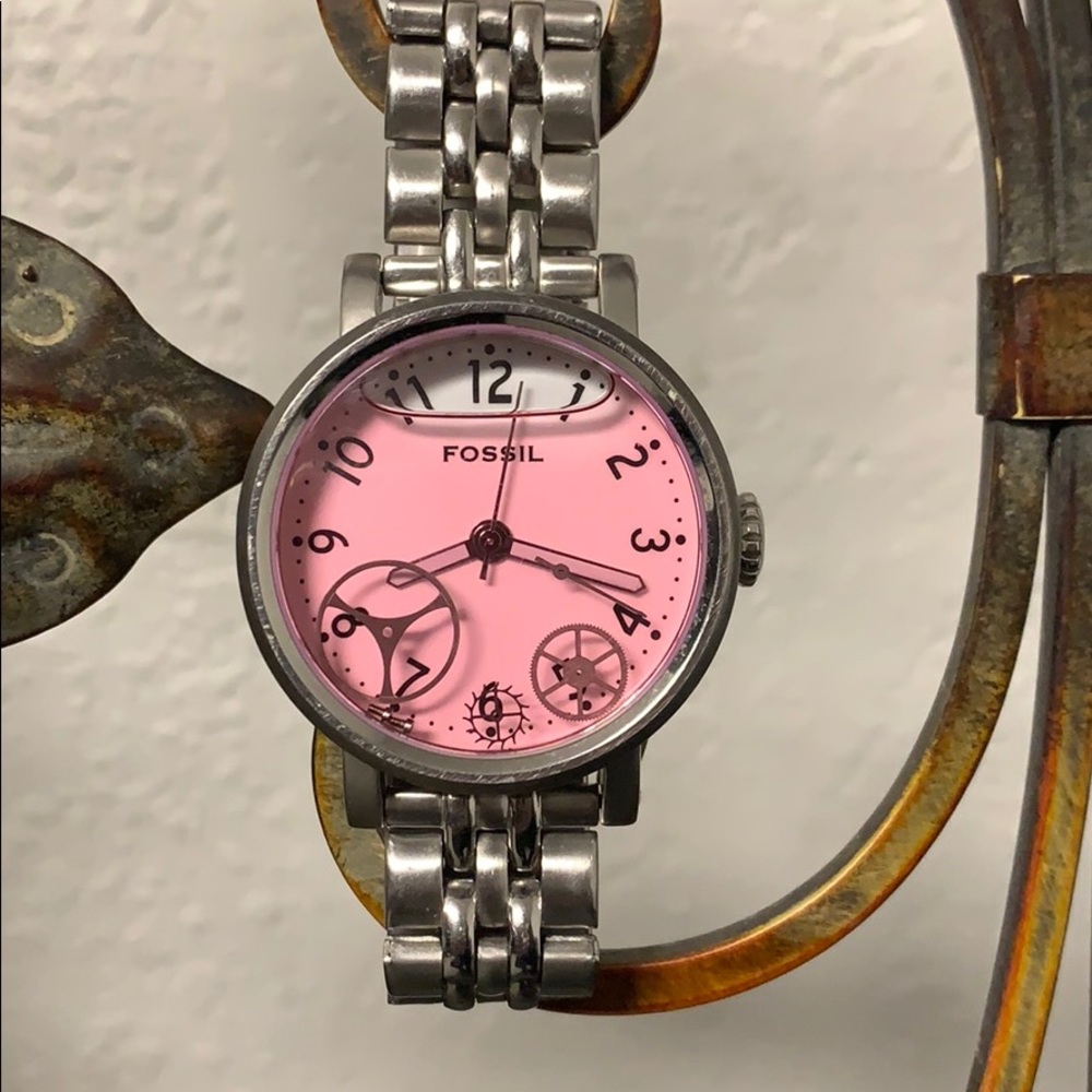 Woman’s fossil watch. White face with pink liquid